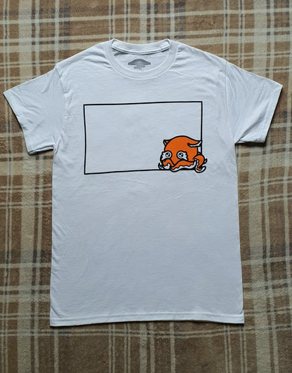 White t-shirt with a graphic design on a plaid fabric background