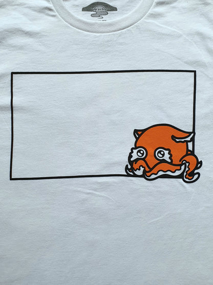 White t-shirt with an orange cartoon character inside a black rectangle on a white background